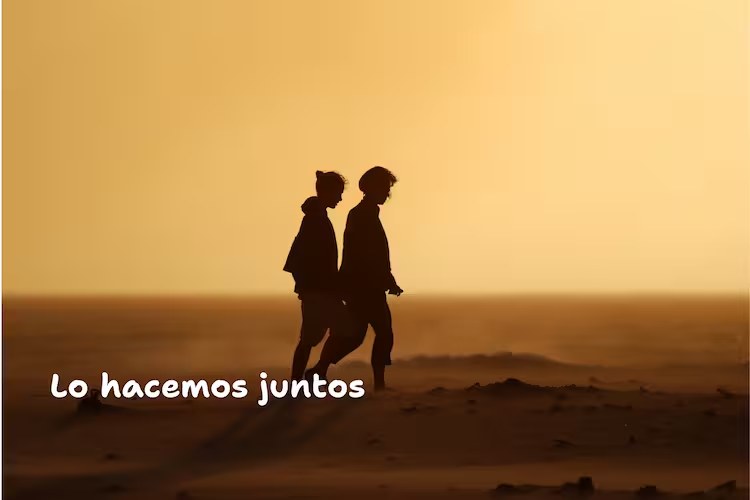Two silhouettes walking together at sunset, with the words "We do it together"